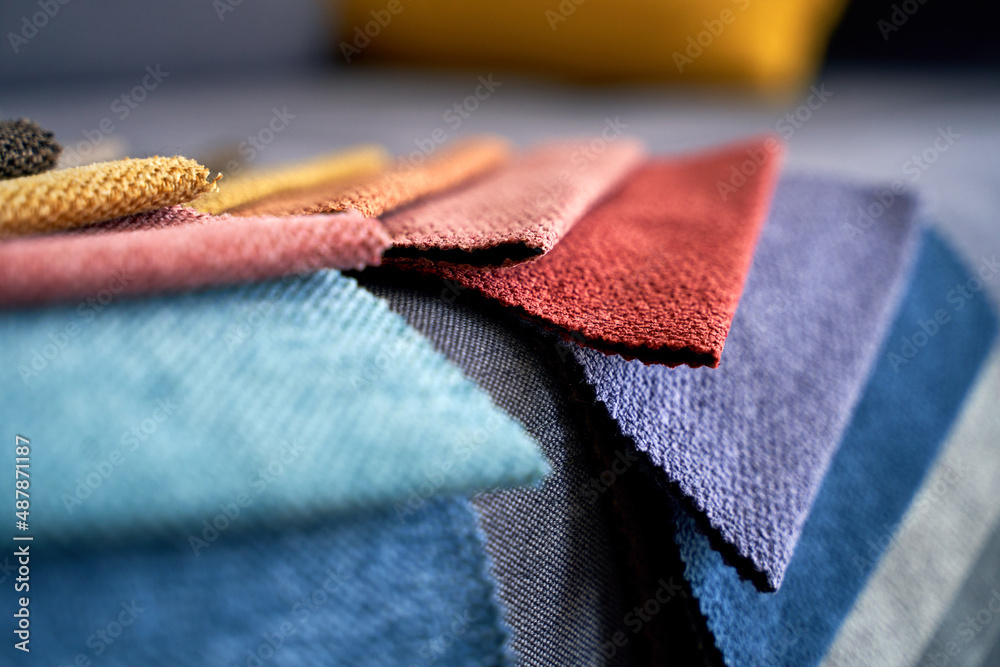 Colorful upholstery fabric samples on the home sofa