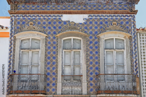 Blue and yellow tile facade-old abandoned townhouse-closed balconies. Tavira-Portugal-110