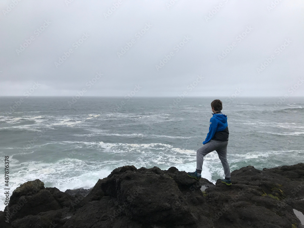 A little boy looking at the ocean