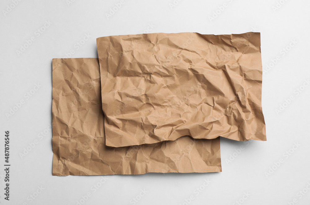 Sheets of brown paper on white background, top view Sheets of brown paper on white background, top view