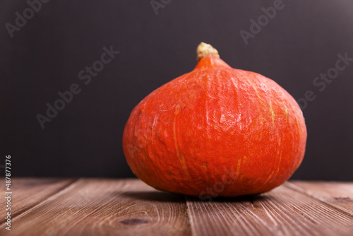 Pumpkin on a wooden table, dark background