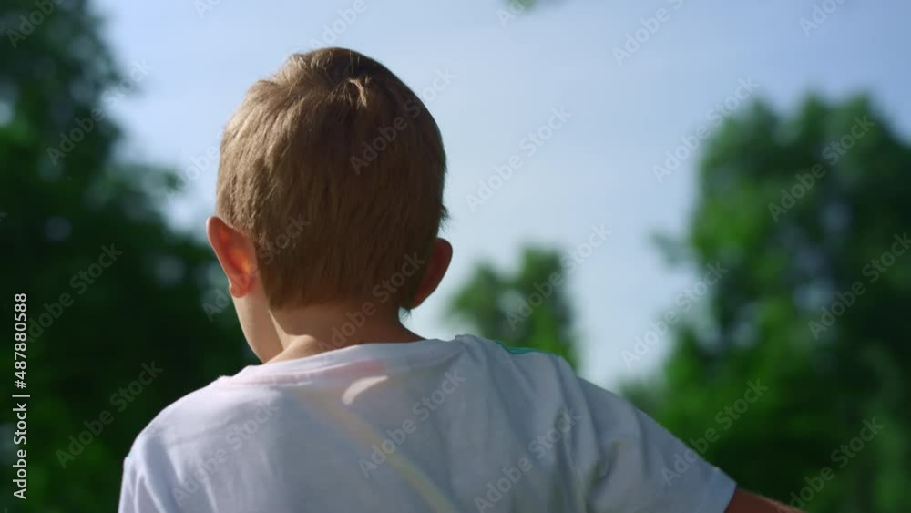 Concentrated boy play football closeup. Active kid training soccer uotdoors. Concentrated boy play football closeup. Active kid training soccer uotdoors.