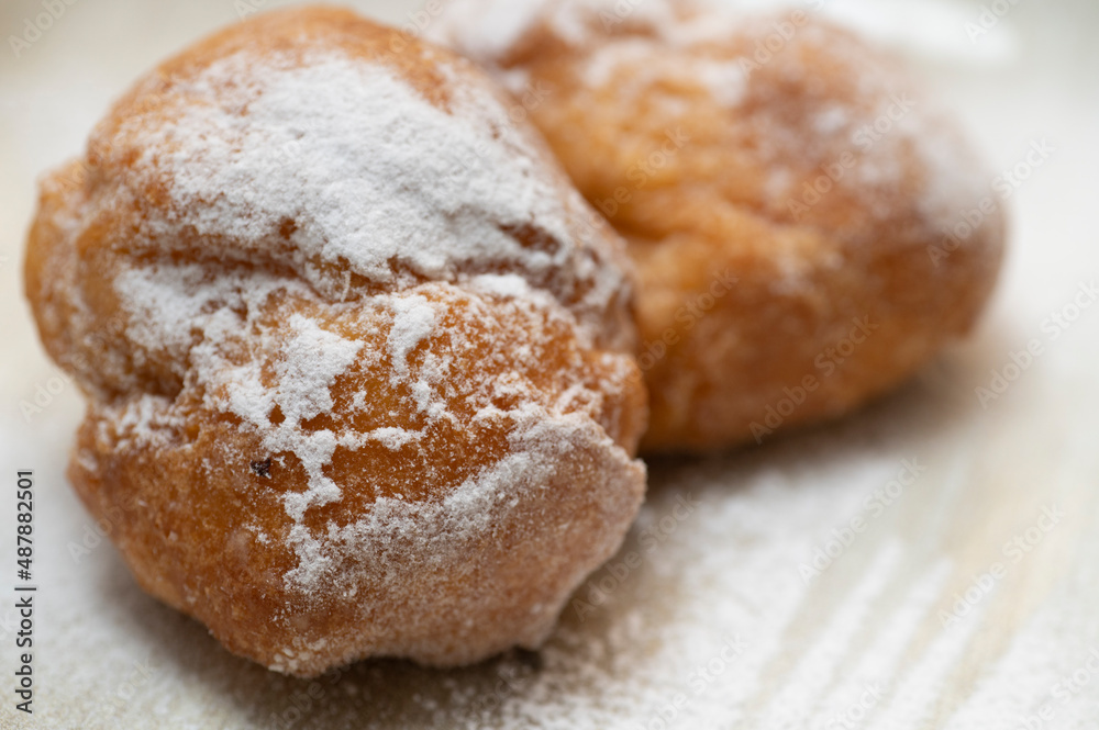 Two cream carnival pancakes or carnival fritters, italian traditional sweet