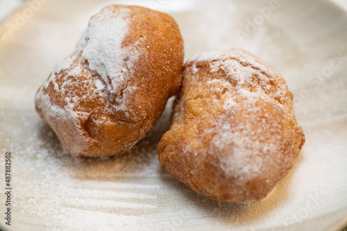 Two cream carnival pancakes or carnival fritters, italian traditional sweet