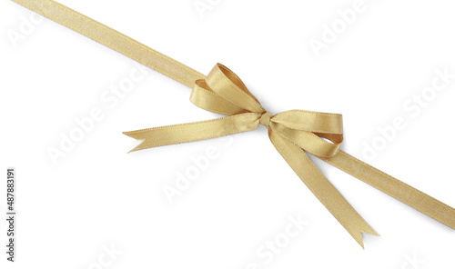 Golden satin ribbon with bow on white background, top view