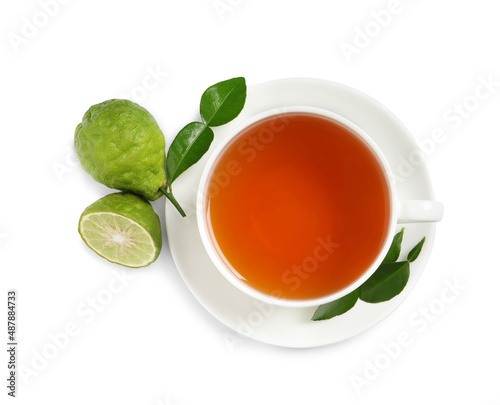 Cup of tasty bergamot tea and fresh fruits on white background, top view