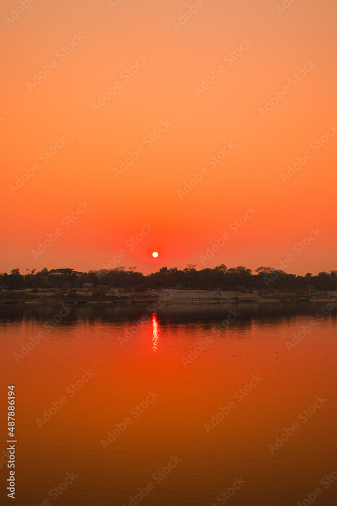 Fototapeta premium Sunset photography on the river in winter 2022. This image was taken by me on January 17, 2022, from the Doleswori river, Bangladesh, South Asia.