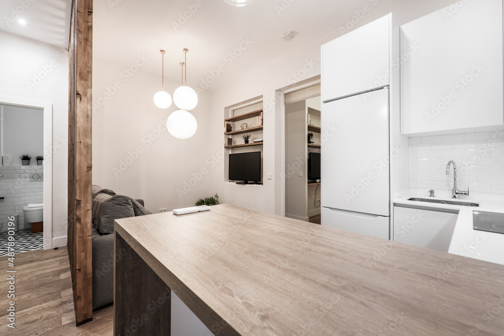 Wooden countertop of a kitchen table with white cabinets in a short-term rental apartment Wooden countertop of a kitchen table with white cabinets in a short-term rental apartment