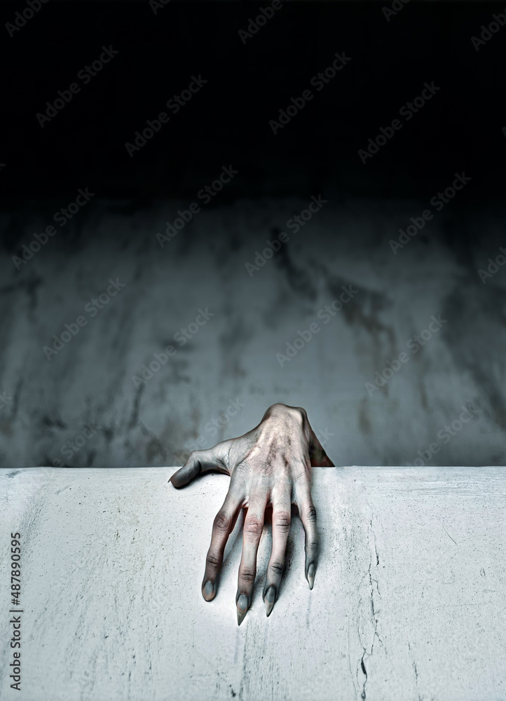 A Scary Hand Reaches out from Under Your Bed Stock Photo