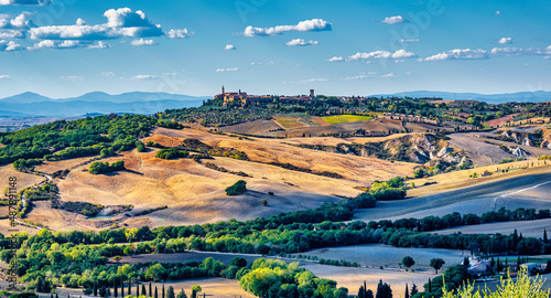 A landscape of Val d'Orcia with the town of Pienza on the hill in Tuscany, Italy photo