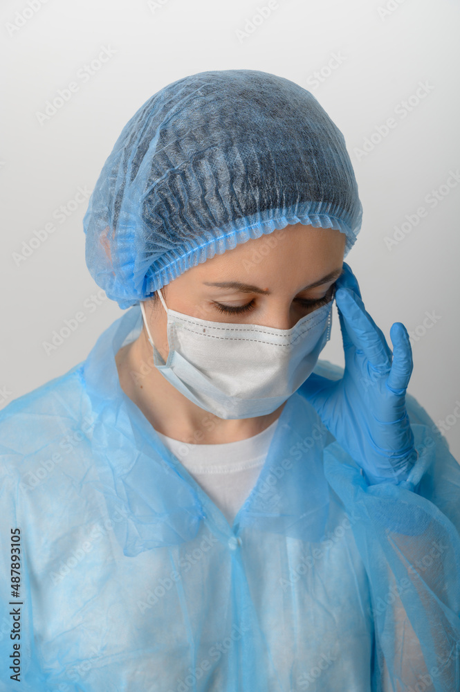 Doctor or nurse in a medical gown, mask and protective gloves Doctor or nurse in a medical gown, mask and protective gloves