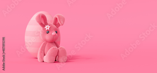 Cute Easter bunny sitting on the floor leaning against the painted egg. Easter holiday concept on pink background 3d render 3d illustration