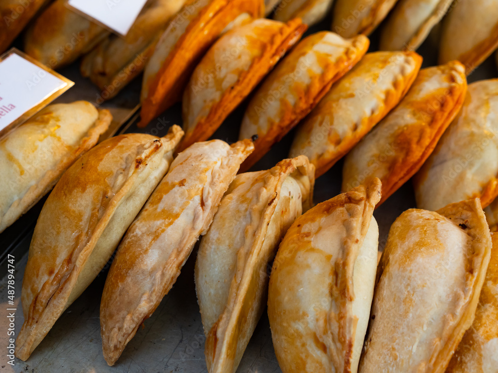 Closeup of baked snack empanada at market, popular spanish street food
