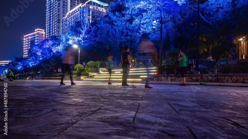 night time illuminated sanya city river bay dancing class panorama 4k hainan island china photo