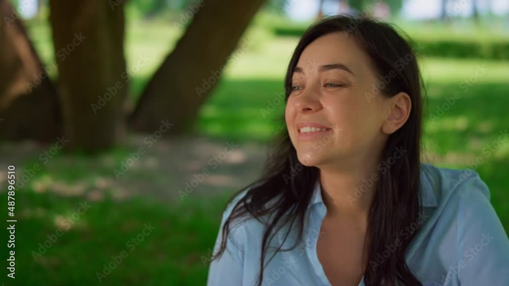Portrait of woman sitting on meadow close up. Happy mother rest outdoors. Portrait of woman sitting on meadow close up. Happy mother rest outdoors.