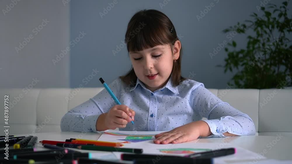 Kids creativity. Child little girl drawing rainbow with colored pencils on paper at home Kids creativity. Child little girl drawing rainbow with colored pencils on paper at home