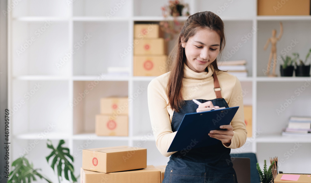 Portrait of Starting small businesses SME owners female entrepreneurs working, box and check online orders to prepare to pack the boxes, sell to customers, sme business ideas online. Portrait of Starting small businesses SME owners female entrepreneurs working, box and check online orders to prepare to pack the boxes, sell to customers, sme business ideas online.