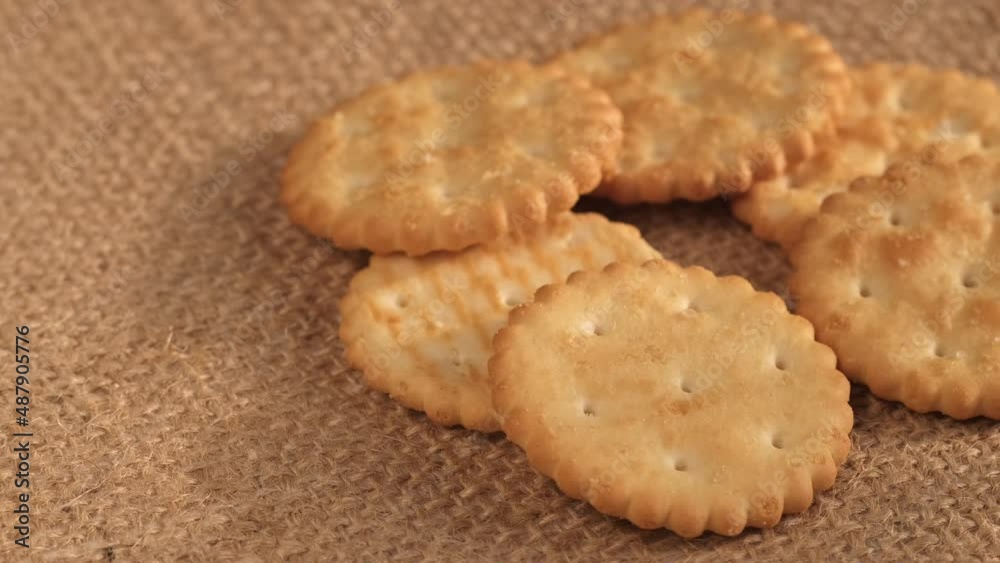 Circle crackers with salt. Close up. Rotating cracker cookies background. Tasty food. Beautiful round crackers on canvas Circle crackers with salt. Close up. Rotating cracker cookies background. Tasty food. Beautiful round crackers on canvas