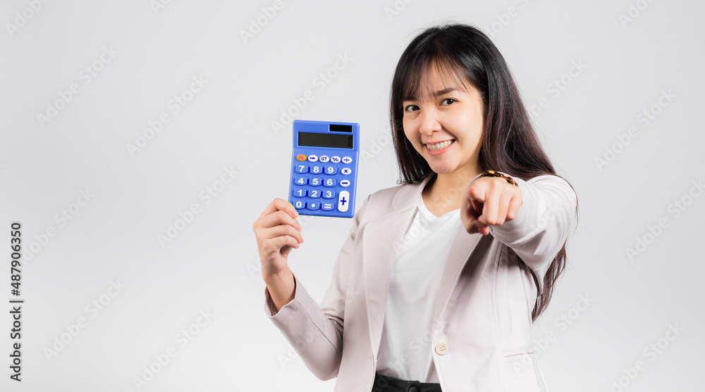 Tax day concept. Woman confident smiling holding calculator and finger point to camera, Portrait excited happy Asian female studio shot isolated on white background, It's time to calculate your taxes Tax day concept. Woman confident smiling holding calculator and finger point to camera, Portrait excited happy Asian female studio shot isolated on white background, It's time to calculate your taxes