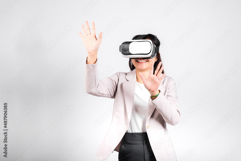 Smiling woman confidence excited wear VR headset device touching air during virtual reality experience isolated white background, Asian happy portrait female playing video game studio shot, copy space Smiling woman confidence excited wear VR headset device touching air during virtual reality experience isolated white background, Asian happy portrait female playing video game studio shot, copy space
