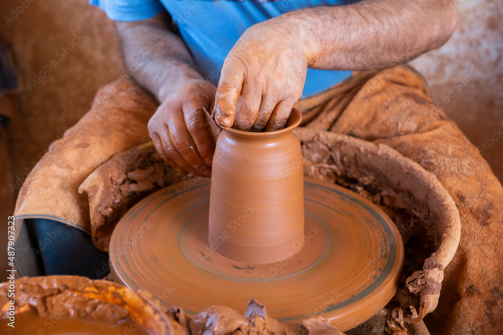Hands of potter making a clay jug closeup. High quality photo