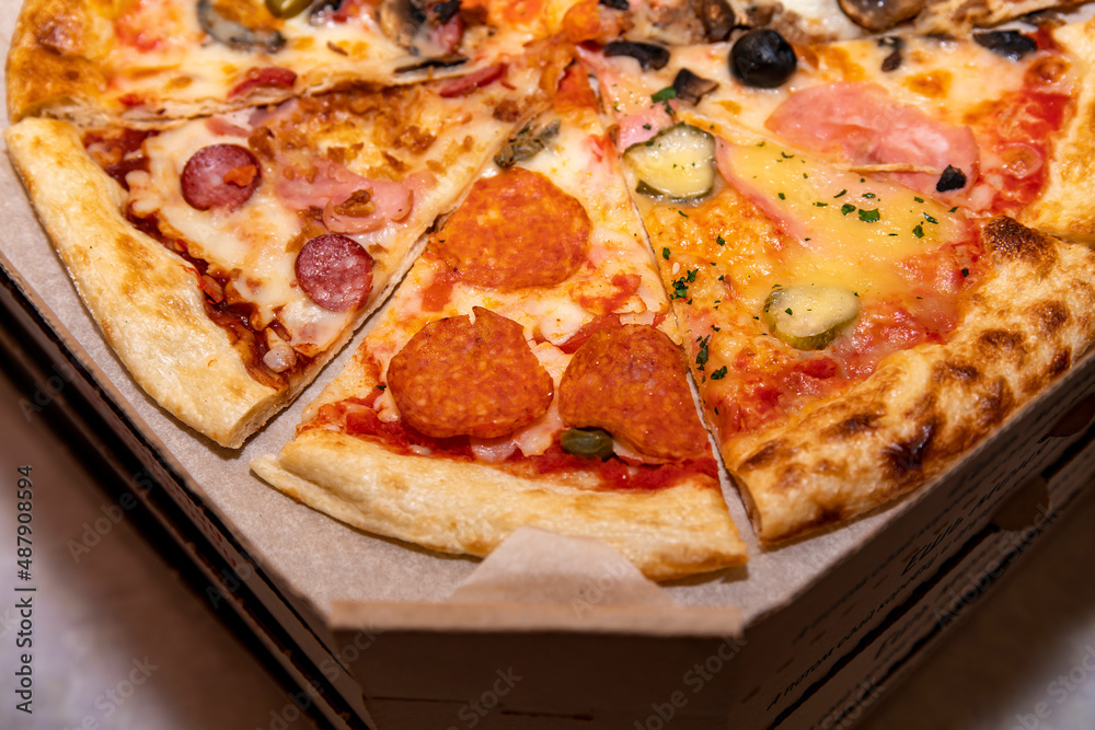 Pizza cut into pieces in a shipping carton. Pizza cut into pieces in a shipping carton.