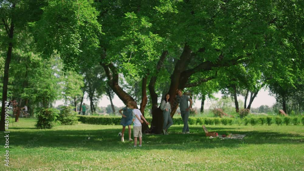 Agile kids playing active games on nature. Happy family enjoying joyful picnic. Agile kids playing active games on nature. Happy family enjoying joyful picnic.
