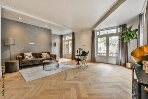 living room interior with large sofa and two floor lamps photo