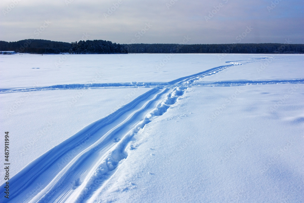 Ski track laid in a snowy field