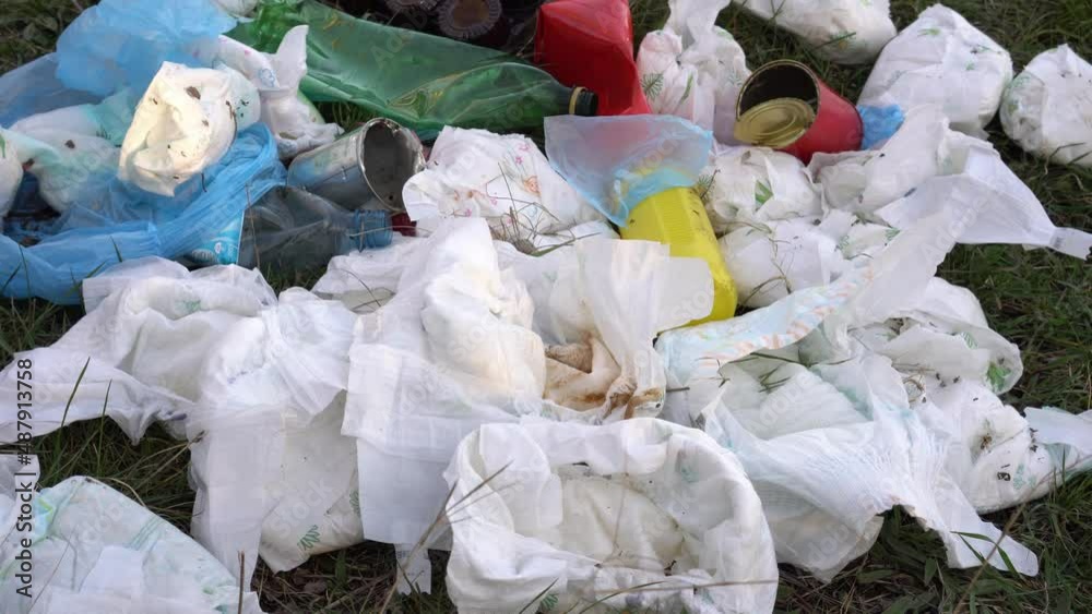 A pile of discarded used baby diapers in landfill. Effects of