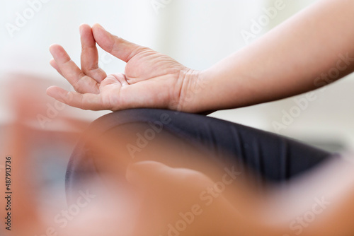  Woman practicing yoga in the bedroom Lotus pose with mudra gesture Mindfulness.