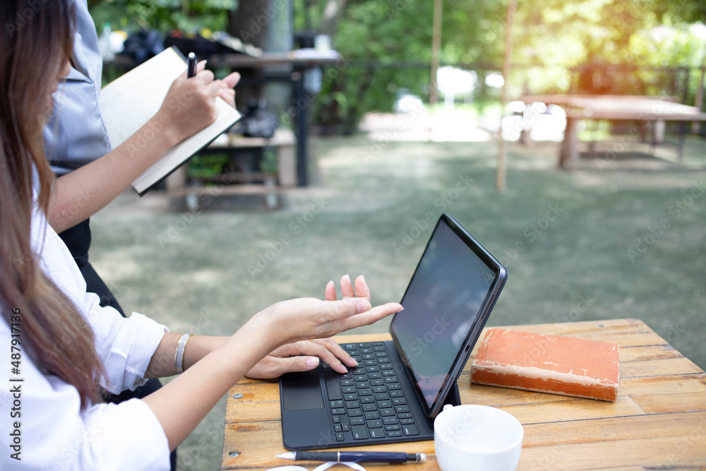 A business woman is teaching online selling through an application on a notebook computer. A business woman is teaching online selling through an application on a notebook computer.