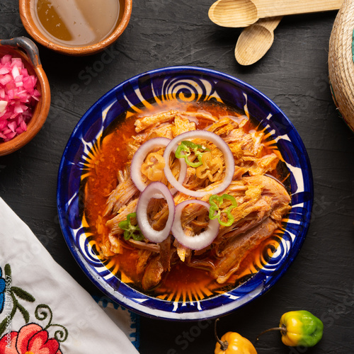 Cochinita pibil with habanero pepper and purple onion. Mexican food photo