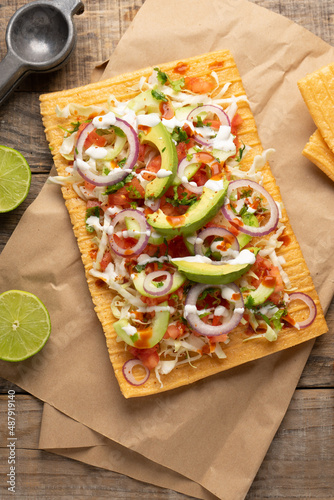 Snack made with wheat flour called chicharron preparado with sauce and vegetables. Mexican food photo