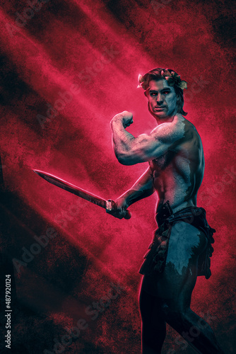 Greek marble warrior with sword posing against red background
