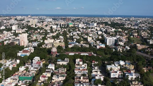 Aerial drone footage of beach, sky, trees, and buildings surrounding Valluvar Kottam photo