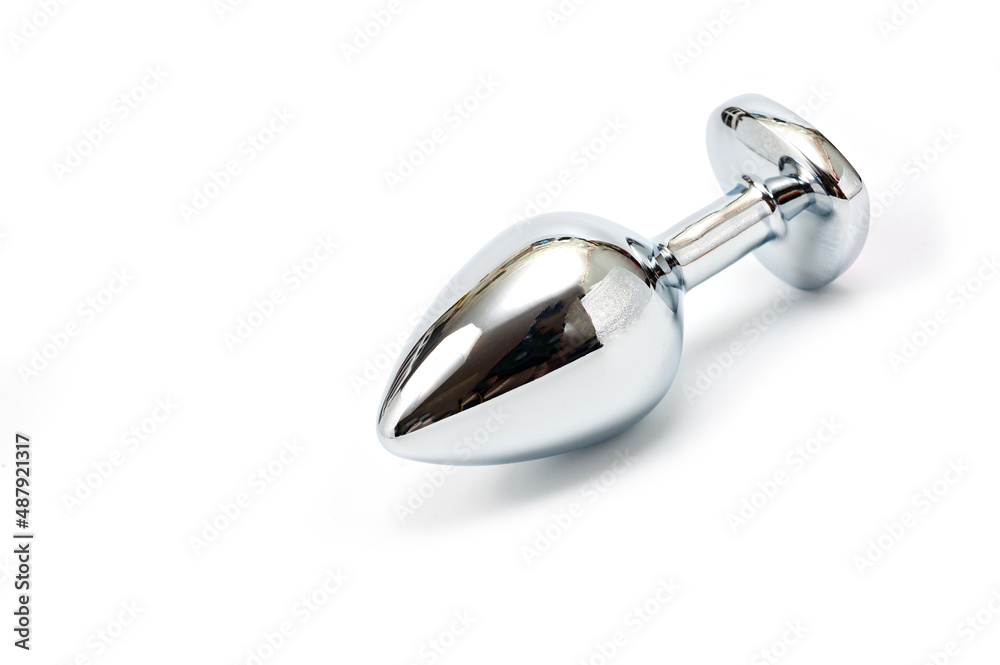 Metal butt plug with a decorative pink heart-shaped stone at the end. Metal butt plug with a decorative pink heart-shaped stone at the end.