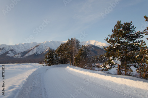 Winter landscape. A snow-covered road leading to the mountains.