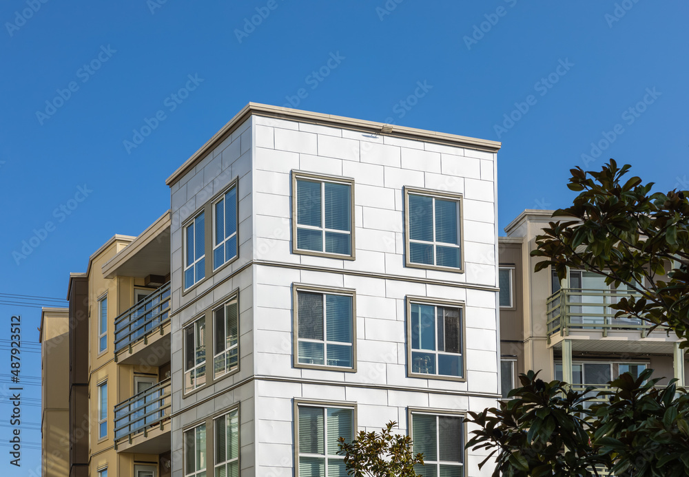 Naklejka premium Brand new apartment building on sunny day in BC, Canada. Architectural details of modern apartment building