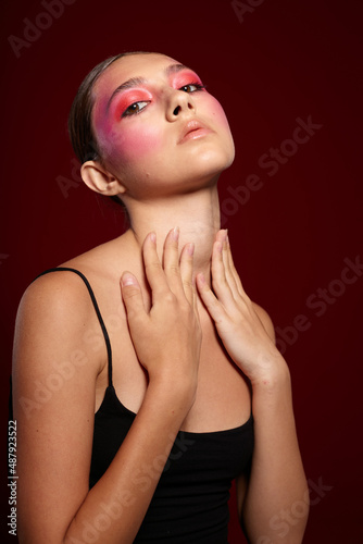 Young beautiful woman posing bright makeup fashion charm pink background unaltered