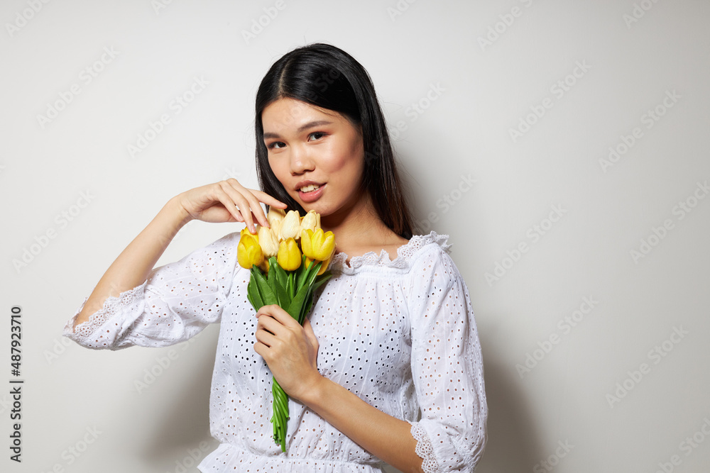 Portrait Asian beautiful young woman romance bouquet of flowers near the face studio model unaltered Portrait Asian beautiful young woman romance bouquet of flowers near the face studio model unaltered