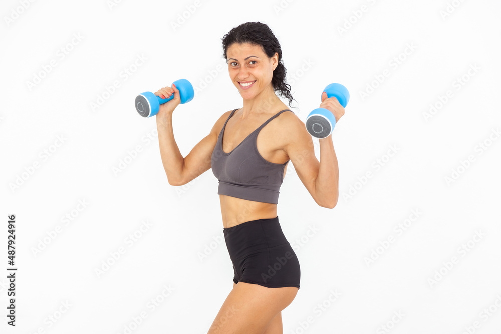 Image of smiling athletic woman with dumbbells isolated on white background Image of smiling athletic woman with dumbbells isolated on white background
