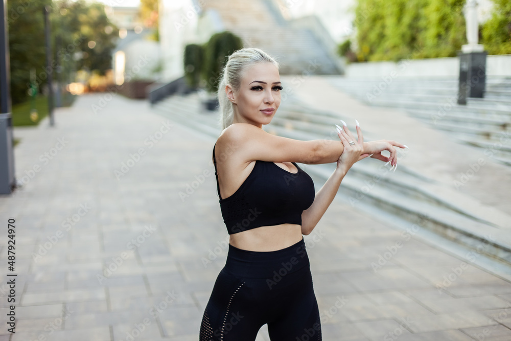 Young fitness woman in sportswear exercising in the city park Young fitness woman in sportswear exercising in the city park