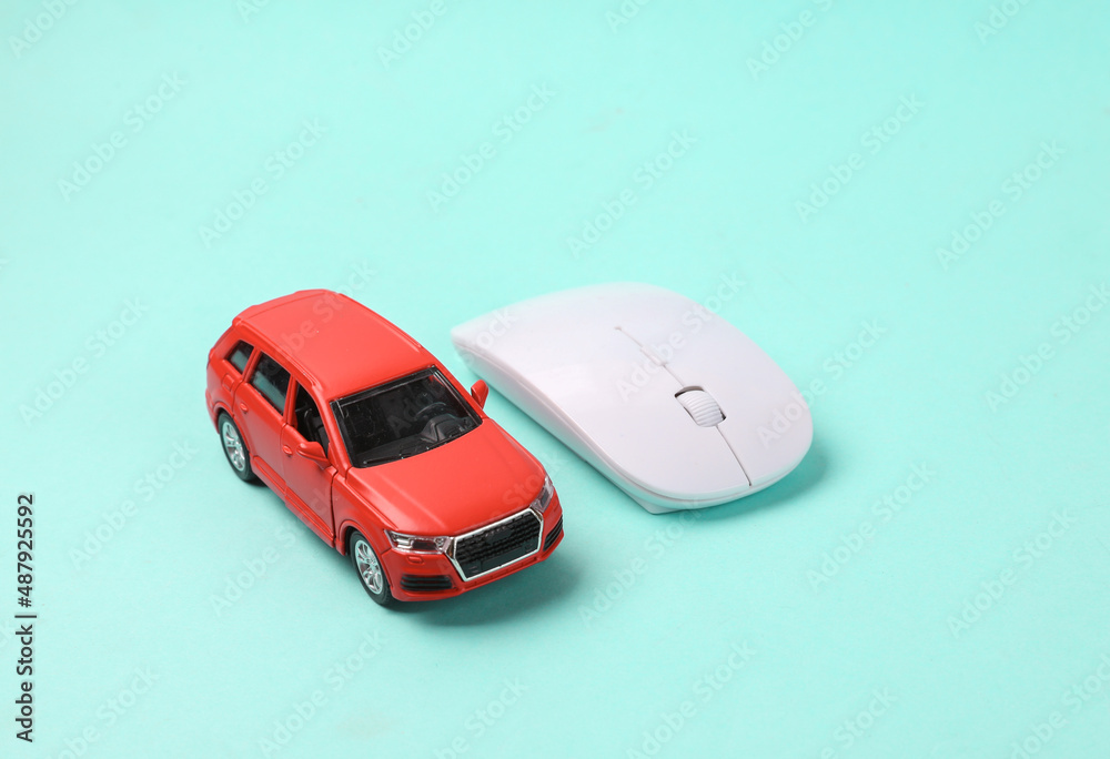 Toy car model with pc mouse on blue background Toy car model with pc mouse on blue background