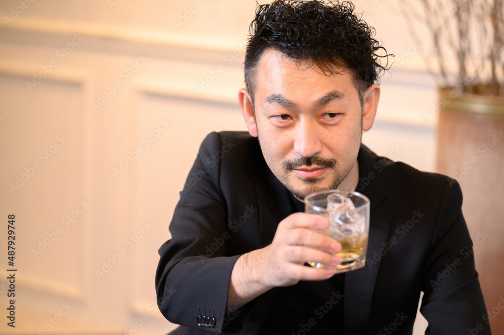 A man making a toast with whiskey. A man making a toast with whiskey.