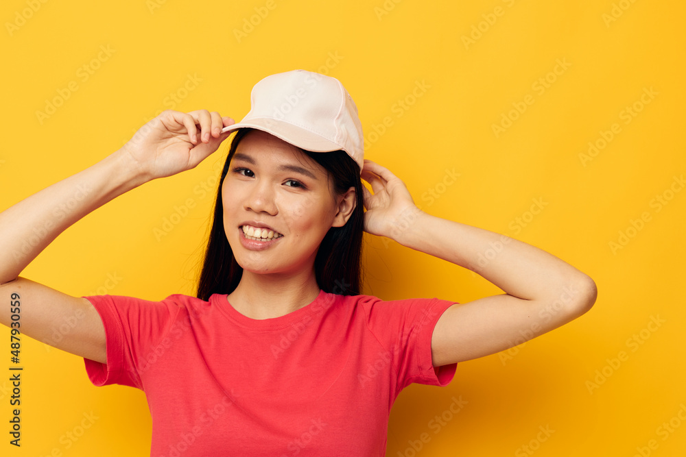cheerful woman of asian appearance in a cap posing