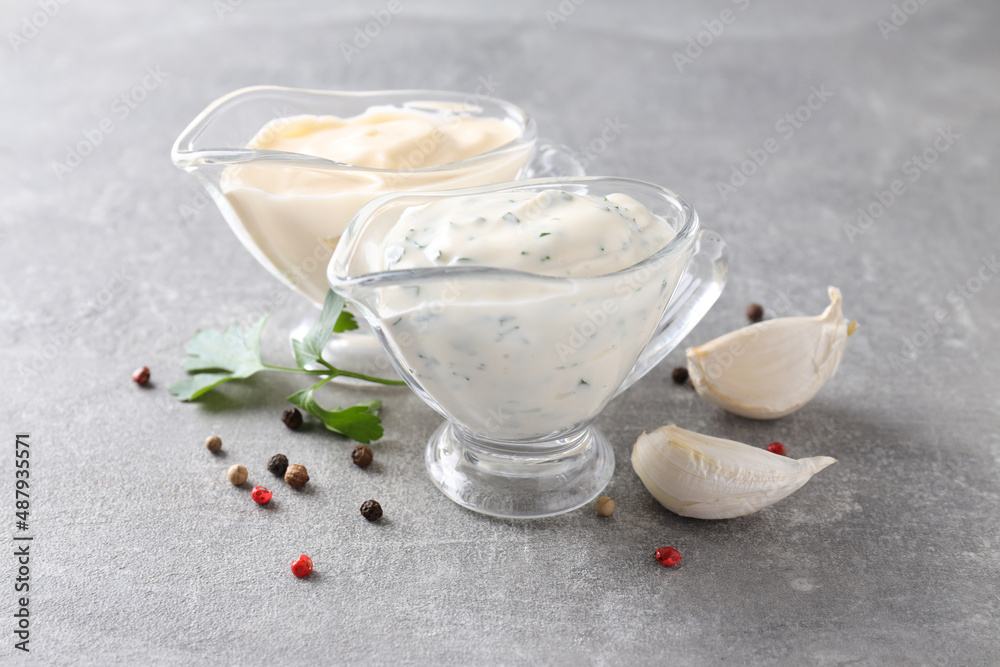 Garlic sauce and ingredients on gray textured background Garlic sauce and ingredients on gray textured background