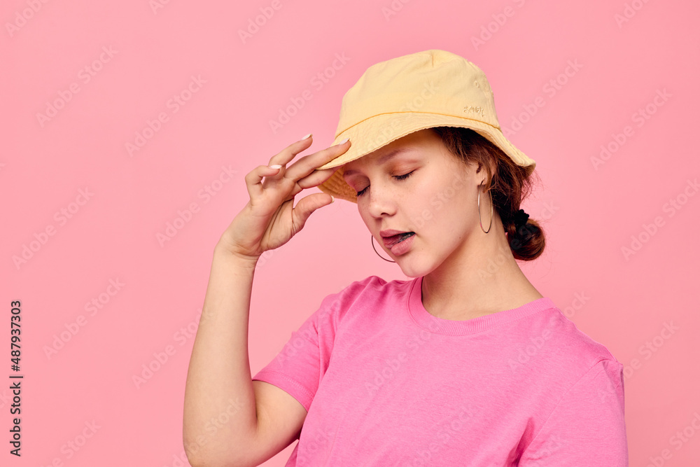 beautiful woman In beige Panama pink t-shirt hand gestures Studio Model beautiful woman In beige Panama pink t-shirt hand gestures Studio Model