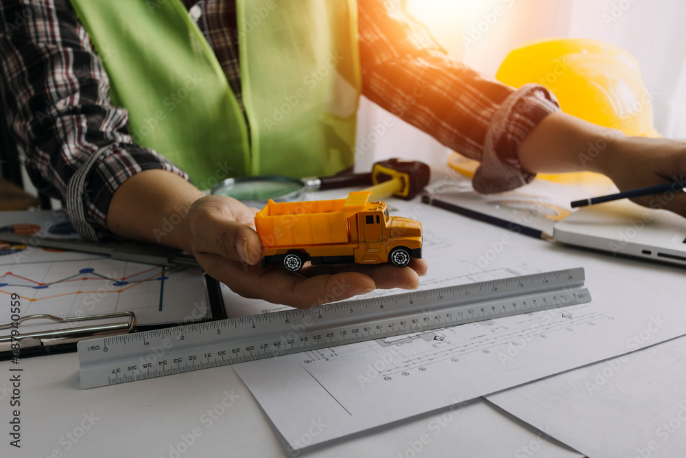 Concept architects, engineer holding pen pointing equipment architects On the desk with a blueprint in the office, Vintage, Sunset light.Selective Focus Concept architects, engineer holding pen pointing equipment architects On the desk with a blueprint in the office, Vintage, Sunset light.Selective Focus