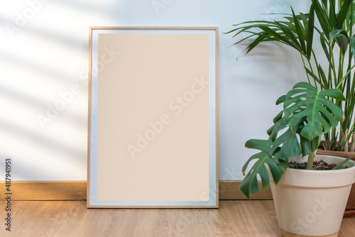 Boho wood frame vertical monograph mockup on clean white walls, plants and sun rays. photo